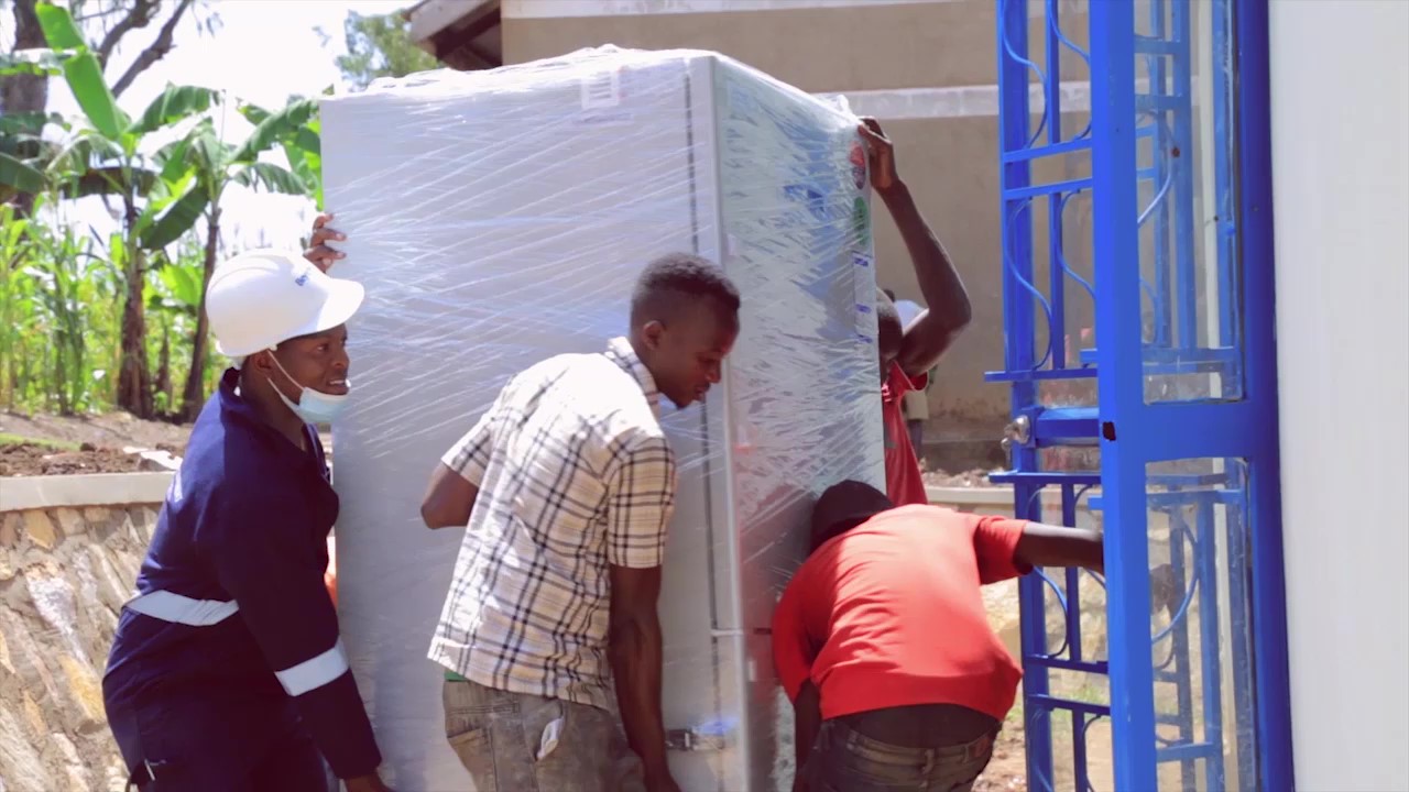 BLL staff delivering and installing Haier solar fridges